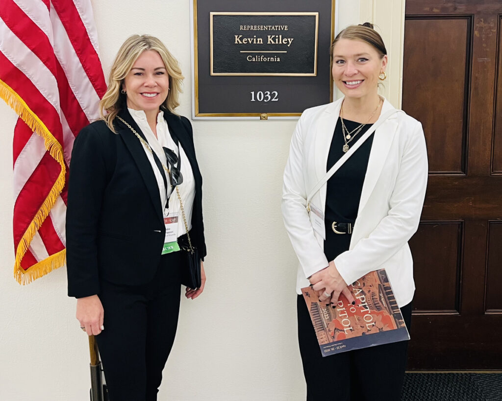 Photo of Krista and Kayla standing next to a plaque of U.S. Representative Kevin Kiley's name